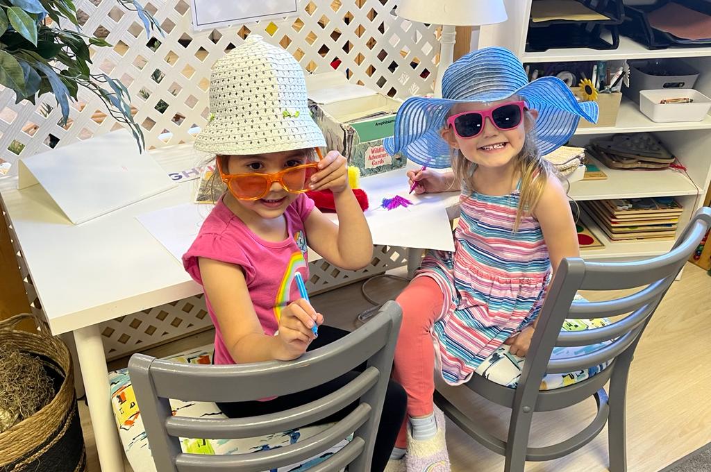 Two girls in sunglasses doing crafts